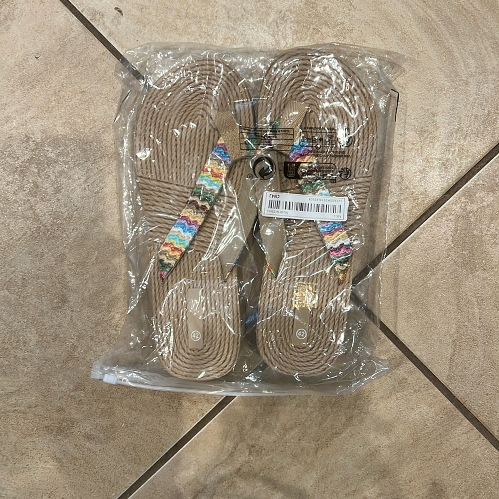 Multicolored straps, rope footbed, plasticc bottoms. Size 10 but more of a 9.